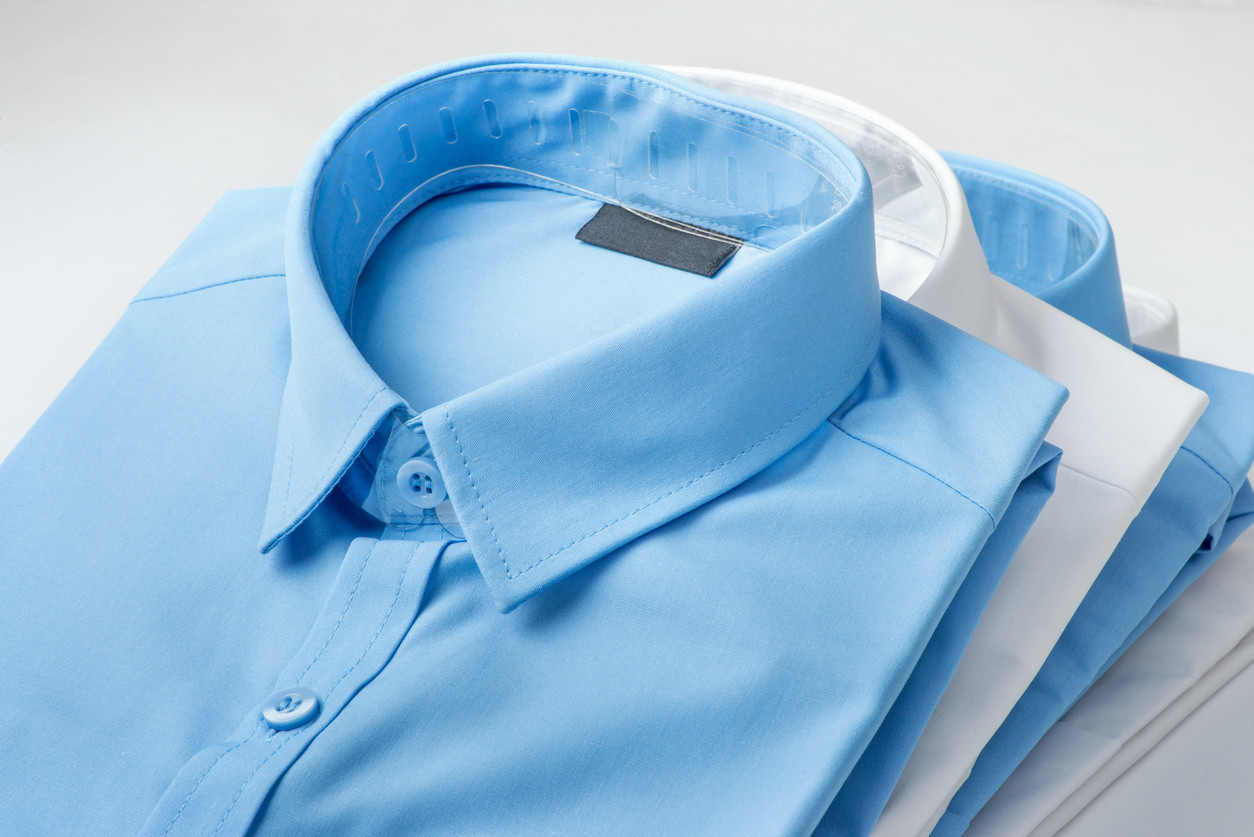 Folded blue and white dress shirts.
